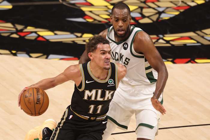 Atlanta Hawks guard Trae Young (11) drives against Milwaukee Bucks forward Khris Middleton (